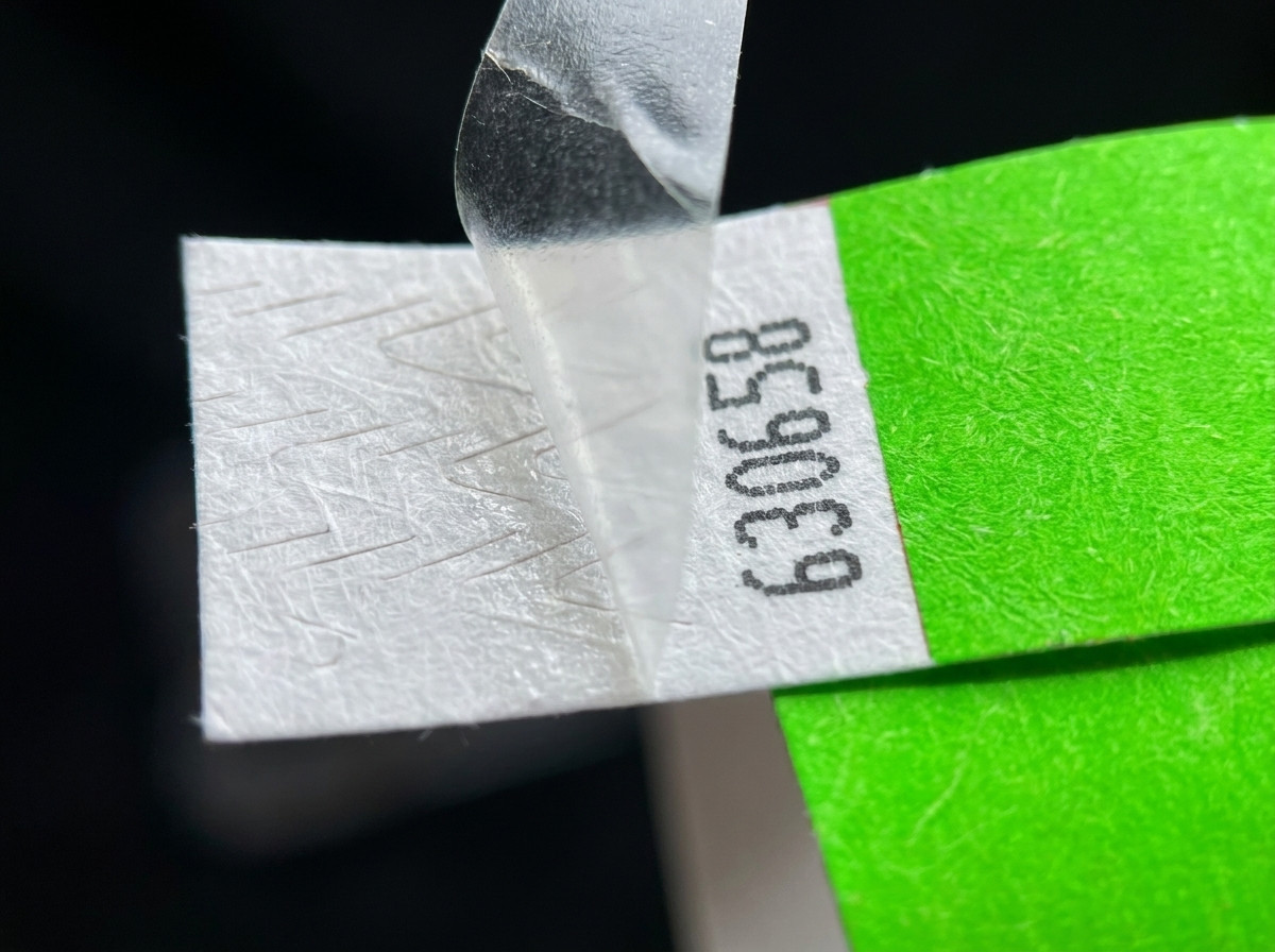 Close-up of the tamper-proof closure of a ID wristband, showing the irreversible clip mechanism