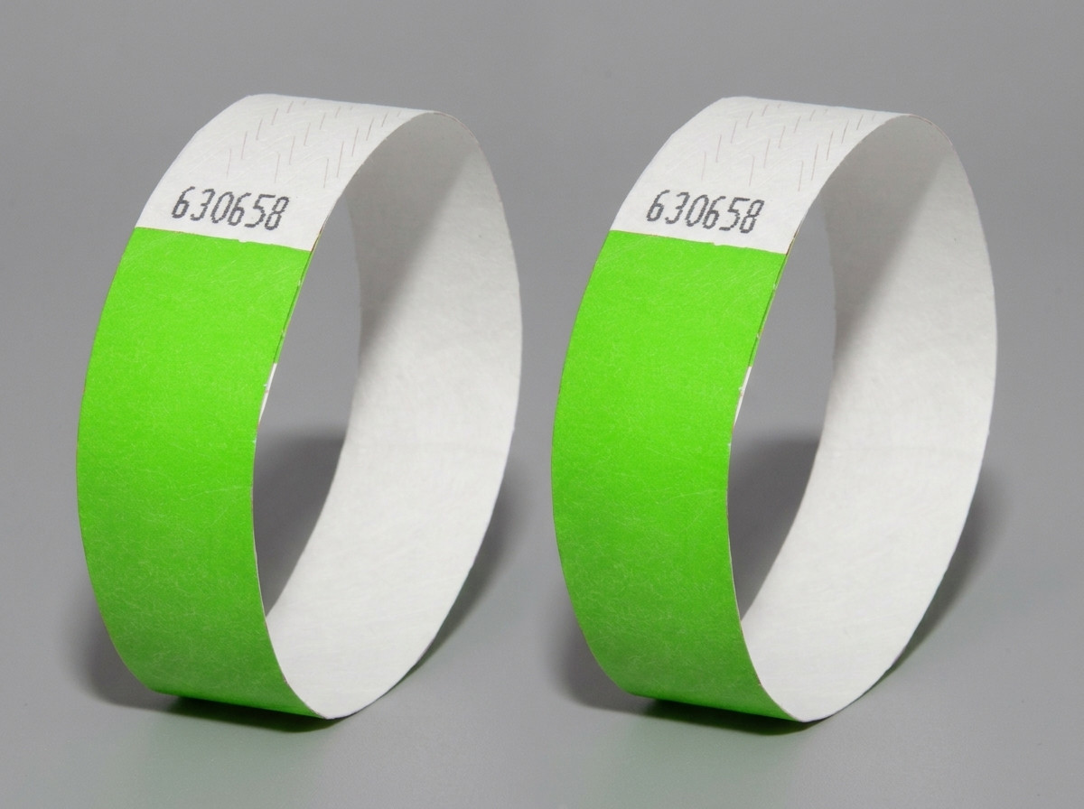 Side-by-side comparison of a Tyvek wristband and a PVC vinyl wristband with high-definition printing of the same festival logo